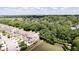 Aerial view of elegant townhomes nestled in a lush, green community with access to a pond at 651 Greenford N Trl, Carmel, IN 46032