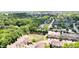 Aerial view of a neighborhood with townhomes, tree-lined streets, and nearby local amenities at 651 Greenford N Trl, Carmel, IN 46032