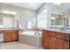 Bright bathroom with double vanity sinks, a soaking tub, and a tile floor at 651 Greenford N Trl, Carmel, IN 46032