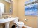 Powder room featuring a pedestal sink, toilet, and artwork on the wall at 651 Greenford N Trl, Carmel, IN 46032