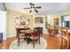 Cozy dining area with fireplace, hardwood floors, and a charming decor at 651 Greenford N Trl, Carmel, IN 46032