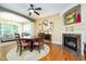 Cozy dining room with a round wooden table, fireplace, and view into a comfortable living space at 651 Greenford N Trl, Carmel, IN 46032