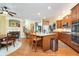 Open-concept kitchen and dining area with a fireplace and hardwood floors at 651 Greenford N Trl, Carmel, IN 46032