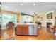 Gourmet kitchen with stainless steel appliances, island seating, and hardwood floors at 651 Greenford N Trl, Carmel, IN 46032