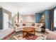 Comfortable living room with stylish furniture, a patterned rug, and a staircase leading to the upper level at 651 Greenford N Trl, Carmel, IN 46032