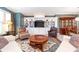 Spacious living room with a decorative rug, built-in shelving, comfortable seating, and a view to the dining area at 651 Greenford N Trl, Carmel, IN 46032