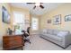 Cozy office with a wooden desk, a comfortable sofa, and natural light at 651 Greenford N Trl, Carmel, IN 46032
