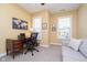 Bright office with a wooden desk, a comfortable sofa, and natural light at 651 Greenford N Trl, Carmel, IN 46032