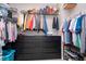 Organized walk-in closet with shelving, hanging rods, and a black chest of drawers at 651 Greenford N Trl, Carmel, IN 46032