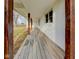 Covered front porch featuring wood flooring and timber posts providing a welcoming outdoor space at 6780 N Michigan Rd, Fairland, IN 46126