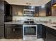 Kitchen featuring stainless steel appliances, granite countertops, and sleek dark cabinetry at 6780 N Michigan Rd, Fairland, IN 46126