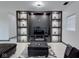Modern living room with a black entertainment center, recessed shelving, and neutral decor at 6780 N Michigan Rd, Fairland, IN 46126