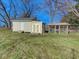 Two outbuildings including storage shed and screened in building on a grassy lot with mature trees at 6780 N Michigan Rd, Fairland, IN 46126