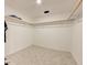 Large, empty walk-in closet with built-in shelving and geometric patterned flooring at 6780 N Michigan Rd, Fairland, IN 46126