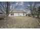 A wide open backyard enclosed by a wood fence and lined by mature shade trees, perfect for outdoor activities and gatherings at 7031 Sea Eagle Ct, Indianapolis, IN 46254
