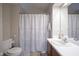 Bathroom featuring single sink vanity, decorative tile floor, and a shower-tub combo at 7031 Sea Eagle Ct, Indianapolis, IN 46254