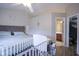 Bedroom showcasing crib, changing table, and access to bathroom and walk-in closet at 7031 Sea Eagle Ct, Indianapolis, IN 46254