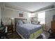 Cozy bedroom featuring a queen-sized bed, decorative shelving and a hardwood floor at 7031 Sea Eagle Ct, Indianapolis, IN 46254