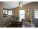 Cozy dining area with a wooden table and chairs, next to the living area and windows at 7031 Sea Eagle Ct, Indianapolis, IN 46254