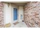 Cozy entryway with a blue-trimmed door and rustic decor on the brick wall at 7031 Sea Eagle Ct, Indianapolis, IN 46254
