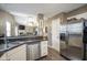 Open concept kitchen with stainless steel appliances, breakfast bar, and modern finishes at 7031 Sea Eagle Ct, Indianapolis, IN 46254