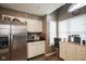 Kitchen area with stainless steel refrigerator, white cabinetry, and island coffee bar at 7031 Sea Eagle Ct, Indianapolis, IN 46254