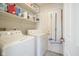 Functional laundry area with a washing machine, dryer, and convenient shelving for storage at 7031 Sea Eagle Ct, Indianapolis, IN 46254