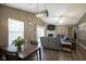 Inviting living room showcasing a dining area, cozy fireplace, and hardwood floors at 7031 Sea Eagle Ct, Indianapolis, IN 46254