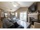 Spacious living room with a brick fireplace, ceiling fan, and sliding glass doors to the backyard at 7031 Sea Eagle Ct, Indianapolis, IN 46254