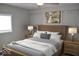 Bedroom featuring a wood bed frame, two side tables, and wall art at 7144 Sandalwood Dr, Indianapolis, IN 46217