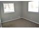 Bedroom with two windows providing natural light, neutral walls, and wall heater at 7144 Sandalwood Dr, Indianapolis, IN 46217