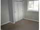 Bedroom featuring sliding closet doors, window with blinds, and neutral color scheme at 7144 Sandalwood Dr, Indianapolis, IN 46217