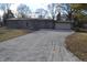 Charming single-story home featuring an attached garage and a long gravel driveway at 7144 Sandalwood Dr, Indianapolis, IN 46217