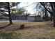Single story home with attached garage, surrounded by trees and grass at 7144 Sandalwood Dr, Indianapolis, IN 46217