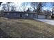 Charming single-story home featuring an attached garage and gravel driveway at 7144 Sandalwood Dr, Indianapolis, IN 46217