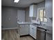 Bright kitchen with white cabinets, stainless steel appliances and granite countertops at 7144 Sandalwood Dr, Indianapolis, IN 46217