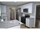 Kitchen featuring stainless steel appliances, granite countertops, and white cabinetry at 7144 Sandalwood Dr, Indianapolis, IN 46217