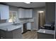 Bright kitchen with white cabinets, stainless steel appliances and granite countertops at 7144 Sandalwood Dr, Indianapolis, IN 46217