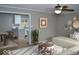 Open-concept living room featuring a ceiling fan, a decorative wall and hardwood floors at 7144 Sandalwood Dr, Indianapolis, IN 46217