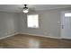 Living room with a neutral color scheme, wood flooring, and a window at 7144 Sandalwood Dr, Indianapolis, IN 46217