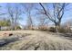 Large backyard featuring mature trees and a firepit area at 8230 E 12Th St, Indianapolis, IN 46219