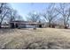 Expansive backyard with mature trees and a rear deck at 8230 E 12Th St, Indianapolis, IN 46219