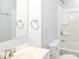 Bright bathroom with a white sink, toilet, mirror, and a shower-tub combination with chrome fixtures at 8230 E 12Th St, Indianapolis, IN 46219
