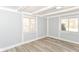 Bright bedroom with two windows and light hardwood floors at 8230 E 12Th St, Indianapolis, IN 46219