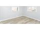 Bright bedroom with modern flooring, fresh paint, and big windows at 8230 E 12Th St, Indianapolis, IN 46219