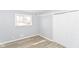 Bedroom with a window and closet, featuring light gray walls and vinyl flooring at 8230 E 12Th St, Indianapolis, IN 46219