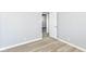 Light gray bedroom featuring vinyl flooring and a doorway leading to another room at 8230 E 12Th St, Indianapolis, IN 46219