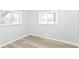 Neutral bedroom showcasing light gray walls, vinyl plank flooring, and a window for natural light at 8230 E 12Th St, Indianapolis, IN 46219