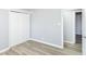 Light-filled bedroom featuring gray walls, vinyl flooring, and a double door closet at 8230 E 12Th St, Indianapolis, IN 46219
