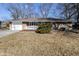 Charming single-story home features a brick facade, white trim, and an attached one car garage at 8230 E 12Th St, Indianapolis, IN 46219